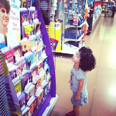 Maggie looking at Justin Beiber Cards